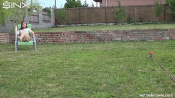 Brunette's Very Wet Sprinkler Frolic Screencap 2 on www.sinx.com