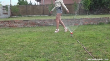 Brunette's Very Wet Sprinkler Frolic Screencap 12 on www.sinx.com